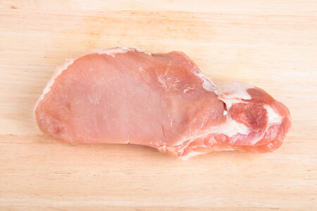 Piece of fresh meat on a wooden boardの写真素材
