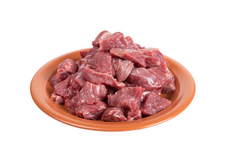 Pieces of beef on a plate isolated on white backgroundの写真素材