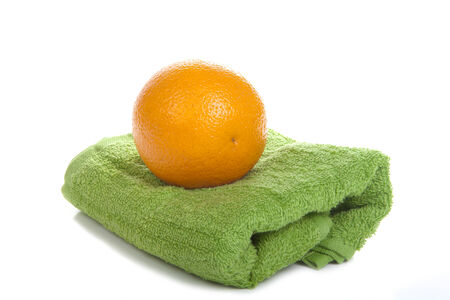 Orange and towel isolated on a white backgroundの写真素材