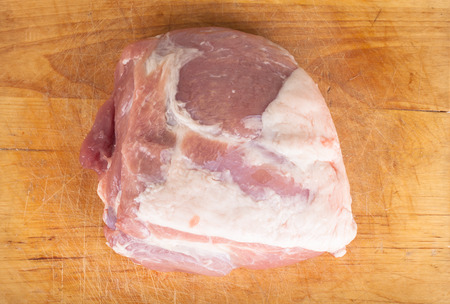 piece of fresh pork on the board. Shallow depth of fieldの写真素材