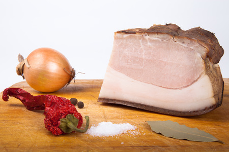 Ukrainian smoked bacon, pepper and  onion  on the old board. Shallow depth of fieldの写真素材
