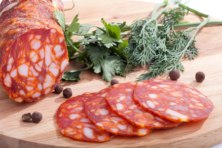 chorizo ââsausage with herbs and pepper on the boardの写真素材