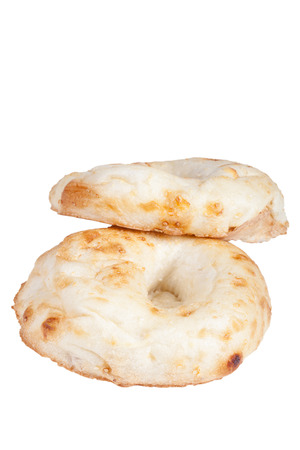 Two Uzbek flatbread with sesame seeds from the tandyr isolated on white backgroundの写真素材