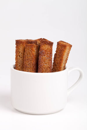 long croutons in a white cupの写真素材