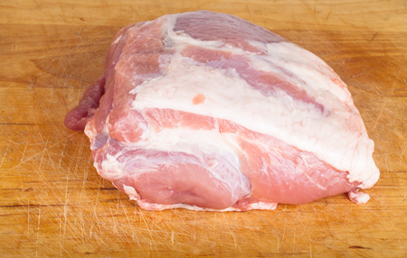 piece of fresh pork on the board. Shallow depth of fieldの写真素材