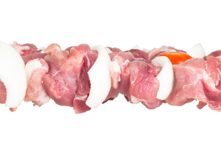 Fresh meat with onion and tomato on a skewer isolated on white backgroundの写真素材