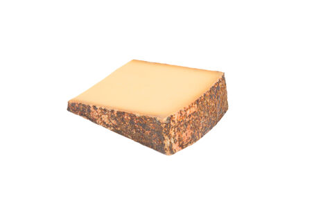 Swiss cheese breaded with spices isolated on a white background.の写真素材