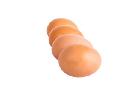 Four eggs isolated on white background. Shallow depth of fieldの写真素材