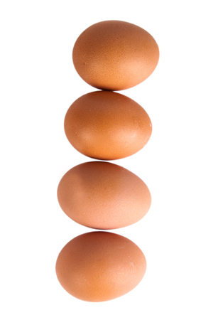Four eggs isolated on white background. Shallow depth of fieldの写真素材