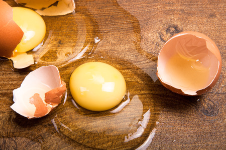 break eggs on the wooden floorの写真素材