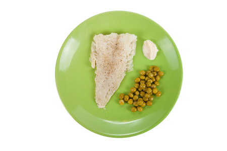 cod fillet with green peas and horseradish sauce on a green plate 
Isolated on white backgroundの写真素材