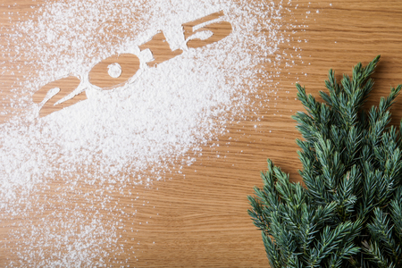 Inscription 2015 on flour and Christmas tree on a wooden tableの写真素材
