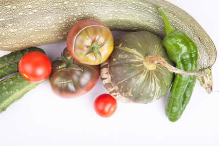 Fresh vegetables assembled from the garden on a bright backgroundの写真素材