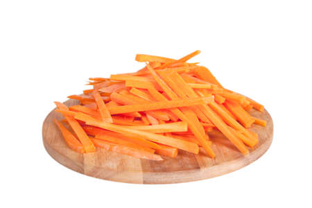 chopped carrot sticks on the board isolated on white backgroundの写真素材