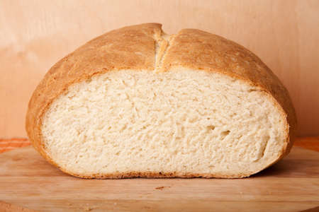 loaf of bread lying on a wooden boardの写真素材