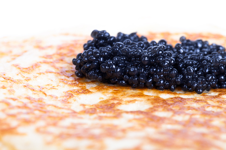 Black caviar on a pancake. Shallow depth of fieldの写真素材
