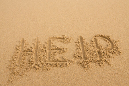 Help - Inscription on the sand of tropical beachの写真素材