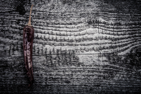 dry pod hot pepper on old wooden backgroundの写真素材