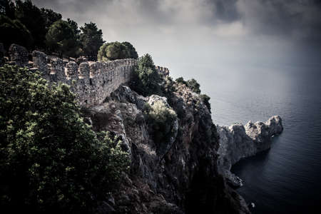 fortification on the edge of a cliff into the sea leaving. dramatic Skyの写真素材