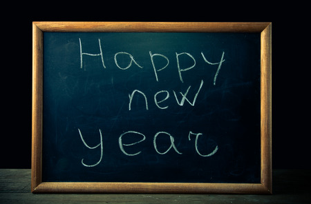 inscription "Happy new year" in chalk on the blackboardの写真素材