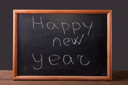 inscription "Happy new year" in chalk on the blackboardの写真素材