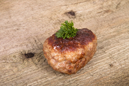 cutlet with parsley leaves on old wooden tableの写真素材