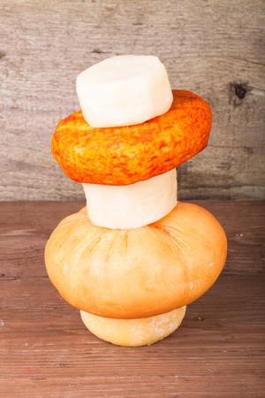 several varieties of cheese on an old wooden tableの写真素材