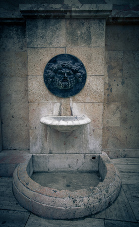 Old broken drinking fountain in the Spanish city. Tintedの写真素材