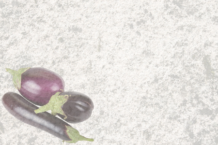 Textured old stone with three eggplantの写真素材
