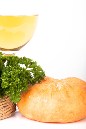 glass of white wine, head cheese, and parsley in a basket on a white backgroundの写真素材