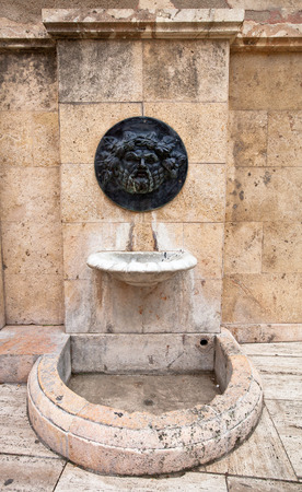 Old broken drinking fountain in the Spanish cityの写真素材