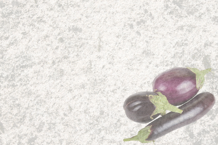 Textured old stone with three eggplantの写真素材