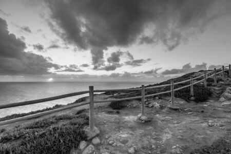 Wooden fence on the edge of Europe. Sunset. black and whiteの写真素材