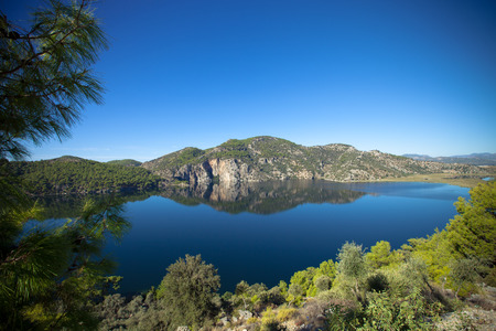 beautiful lake surrounded by mountainsの写真素材