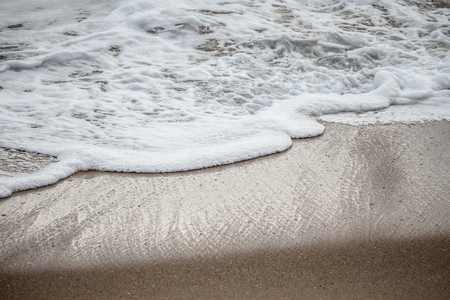 Soft wave of the sea on the sandy beachの写真素材