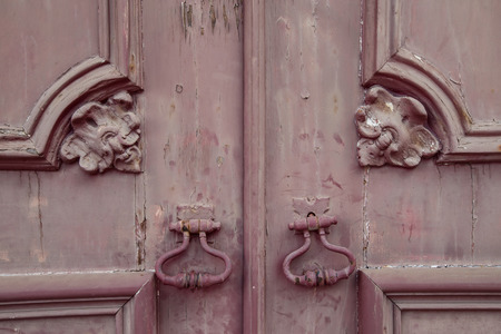 Fragment of old wooden door with metal knobの写真素材