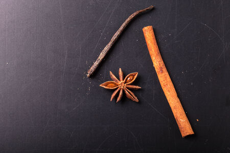 Close up of winter spices , cinnamon, anise, vanilla and brown sugar for christmas cake