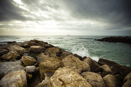 In anticipation of the storm. Dramatic sky on the stone coast of the Atlantic Oceanの写真素材