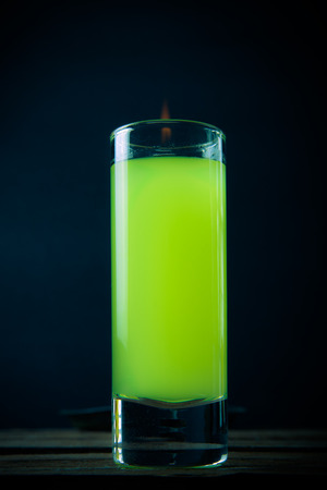 glass with a drink by the fire on a black backgroundの写真素材
