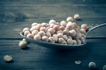 dry peas in a silver spoon on a wooden table. tintedの写真素材