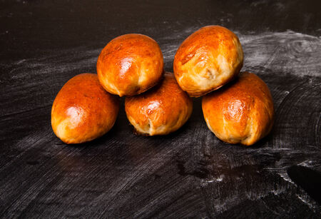 pies with meat or cabbage on a black background.の写真素材