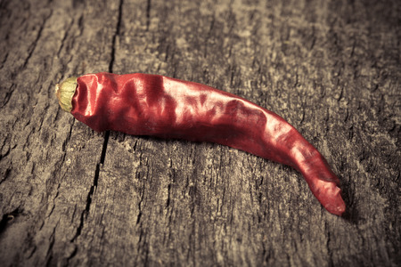 Red hot chili peppers on old wooden tableの写真素材