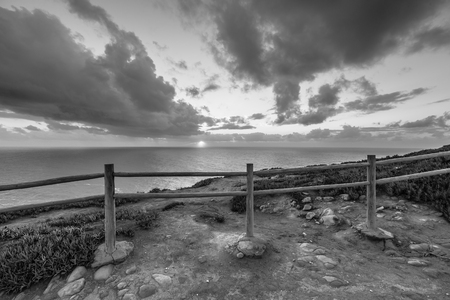 Wooden fence on the edge of Europe. Sunset. black and whiteの写真素材