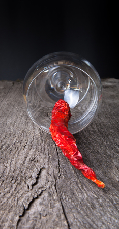 red hot chili peppers in a glass on a dark wooden backgroundの写真素材