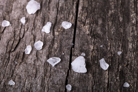 sea salt in an old utensils on wooden tableの写真素材