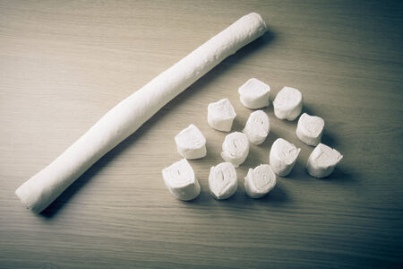 Pieces of dough on the wooden board. Toned.の写真素材