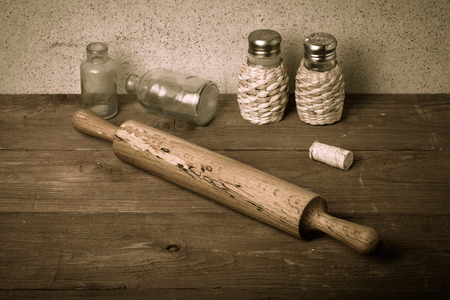 Salt, pepper, rolling pin, old bottles and cork on the old wooden table. Table.の写真素材