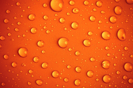 Drops of water on the colored background.の写真素材