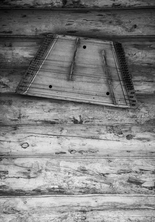 Ancient musical instrument gusli on the wooden floor. Toned.の写真素材