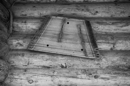 Ancient musical instrument gusli on the wooden wall. Toned.の写真素材